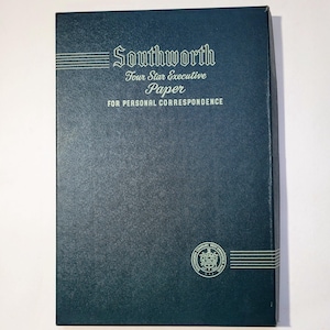 May include: A teal-colored box of Southworth Four Star Executive Paper for personal correspondence. The box has a textured surface and white text that reads "Southworth" and "Four Star Executive Paper". A circular emblem is in the lower right corner.