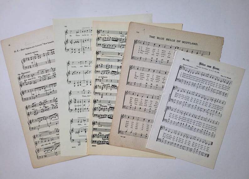 May include: A collection of vintage sheet music featuring songs like "The Blue Bells of Scotland" and "Wider den Kreuzzug". The music is printed on aged paper with a slightly yellowed hue.