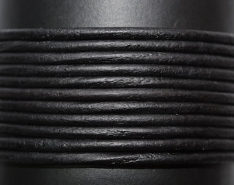 May include: Close-up of black leather cord, showing the texture and detail of the material.