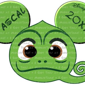 May include: Green chameleon character with large eyes and a curled tail. The character has a green ear with the text "PASCAL" and another green ear with the text "DISNEY ADVENTURE 20XX".