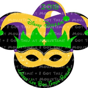 May include: A black Mickey Mouse head silhouette with a purple and yellow jester hat, green and gold crown, and a gold mask. The text "Disney Dream 2018" is on the hat and "Laissez Les Bon Temps Rouler!" is on the bottom of the head.