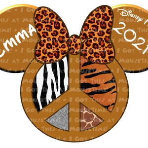 May include: Brown Mickey Mouse ears with a peace sign in the center. The peace sign is decorated with animal print patterns, including zebra, tiger, giraffe, and crocodile. The ears are decorated with a leopard print bow and the text "Emma" and "Disney Magic 2021" on each ear.