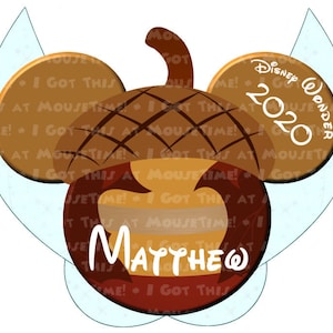 May include: A brown and white Mickey Mouse ear hat with a brown acorn design. The hat has the text "Disney Wonder 2020" on one ear and the name "MATTHEW" on the other ear.