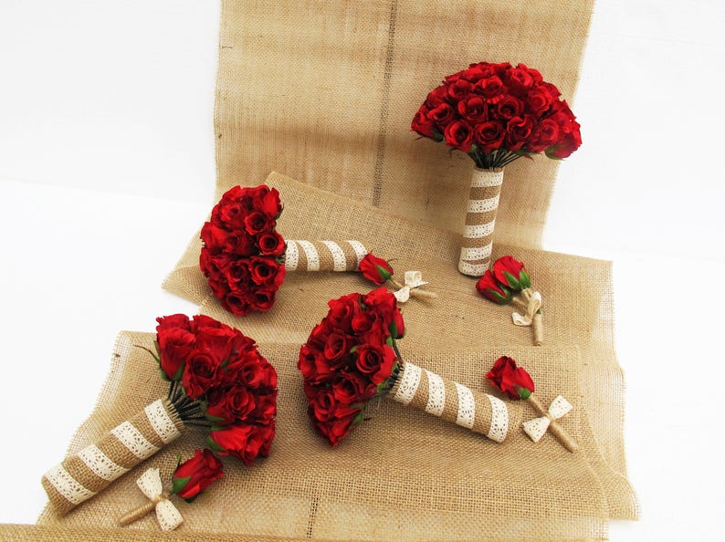 May include: Set of four red rose bouquets with burlap and lace wrapping. The bouquets are arranged on a burlap surface.