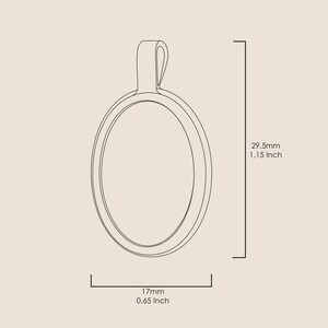 A silver oval pendant with a loop at the top for hanging. The pendant is 29.5mm tall and 17mm wide. The pendant is 1.15 inches tall and 0.65 inches wide.