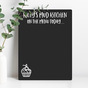 May include: Black chalkboard with white text that reads "Riley's Mud Kitchen On The Menu Today..." and a white cupcake illustration.