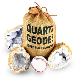 May include: A burlap sack labeled "QUARTZ GEODES STORE FOR KNOWLEDGE" stands among several quartz geodes and a baseball. The geodes are open, revealing crystal formations in shades of white and blue. The baseball is white with red stitching.