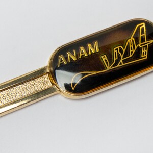 Tie bar/clip Vintage  - ANAM Tie Bar of goldtone metal with logo on black #957
