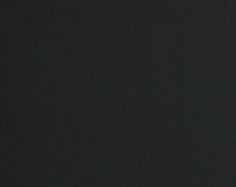 May include: A close-up of a solid black, textured surface. The texture has a fine grain, possibly leather or a similar material. The lighting is even, with no visible shadows.