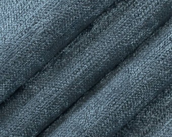 May include: Close-up of a blue textured fabric with a subtle sheen. The fabric has a slightly rough, almost pebbled texture.