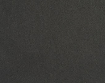 May include: A dark grey textured fabric surface.