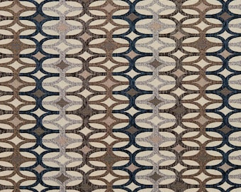 May include: A fabric swatch with a repeating geometric pattern in shades of brown, blue, and beige. The pattern features interlocking circles and diamonds.
