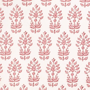 May include: A white background with a repeating pattern of pink floral designs. The floral designs are stylised and resemble a paisley pattern.
