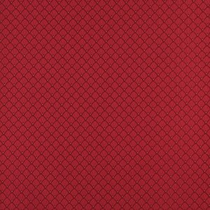 May include: Red fabric with a repeating pattern of small, overlapping circles. The fabric has a textured surface.