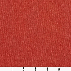 May include: A close-up of a red fabric with a textured surface. The fabric has a subtle sheen and a slightly rough feel.