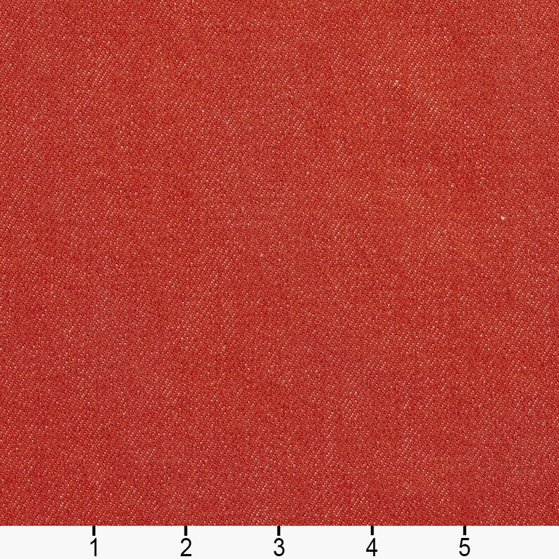 May include: A close-up of a red fabric with a textured surface. The fabric has a subtle sheen and a slightly rough feel.