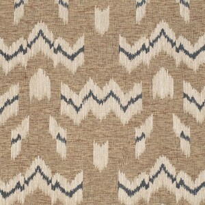 May include: A brown fabric with a white and blue geometric pattern. The pattern is a series of zigzags and wavy lines.