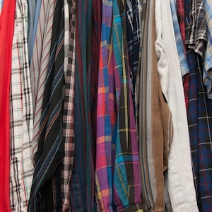 May include: A collection of plaid shirts in various colours and patterns, including red, blue, green, and black.