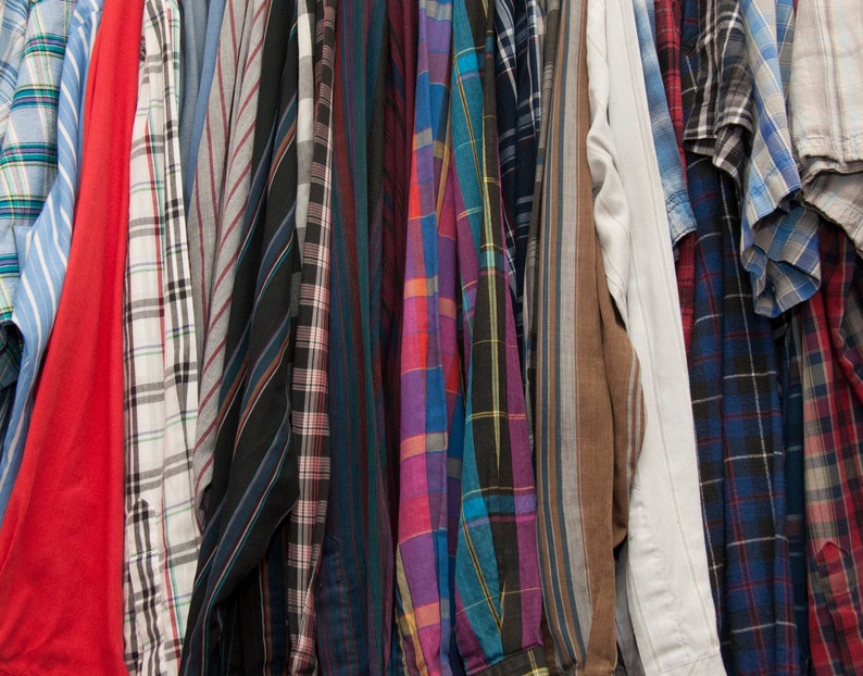 May include: A collection of plaid shirts in various colours and patterns, including red, blue, green, and black.