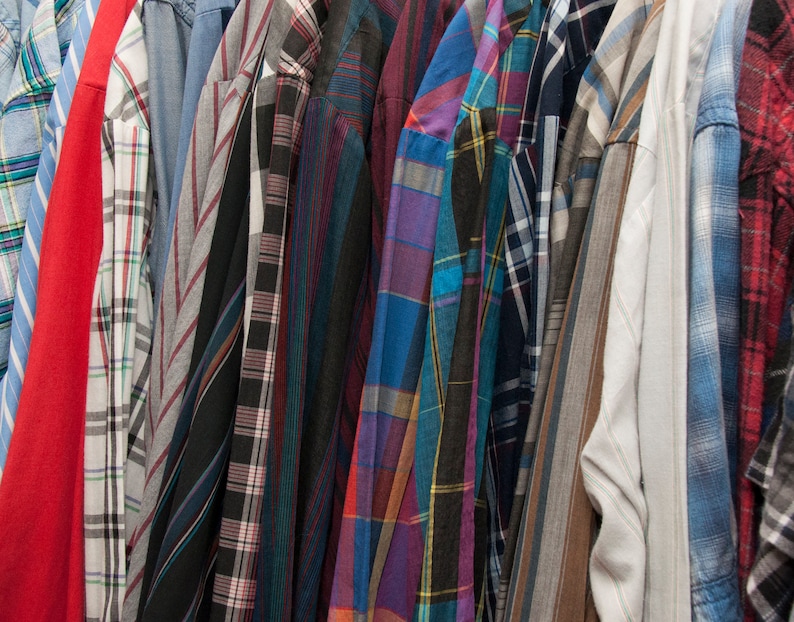 May include: A collection of plaid shirts in various colours and patterns, including red, blue, green, and black.