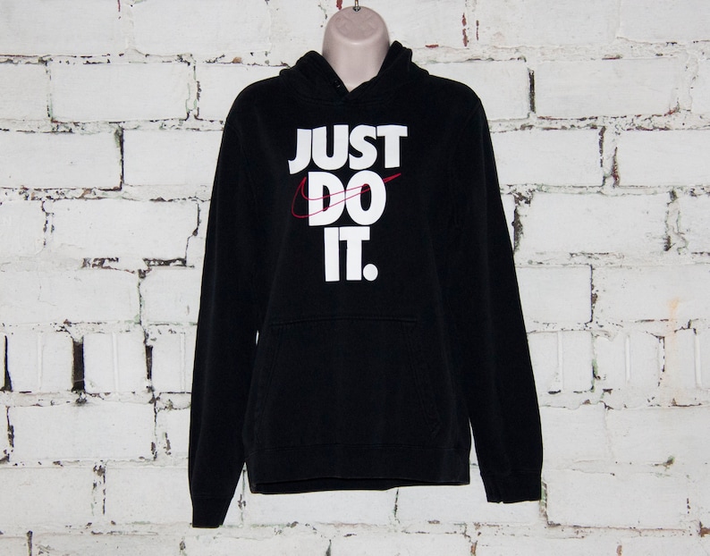 May include: Black hooded sweatshirt with a white "Just Do It" logo and a red swoosh.
