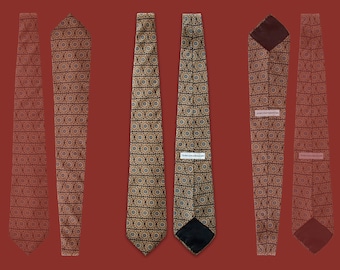 May include: Six different views of a patterned tie with a gold and blue geometric design. The tie is made of a silky fabric and has a pointed tip.
