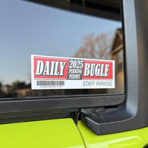 May include: A red and white sticker with the text "DAILY 2025 PARKING PERMIT BUGLE" and "STAFF PARKING". The sticker has a barcode with the number "490000238508675309".