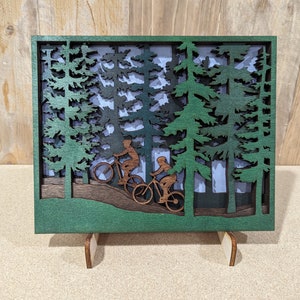 Two Mountain Bikers in the woods scene. Layered wood sign Medium Size.