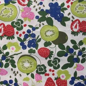 May include: A white fabric with a repeating pattern of green leaves, red strawberries, kiwi fruit, and blue blueberries. The pattern is stylized and has a retro feel.