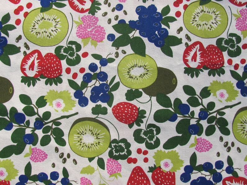 May include: A white fabric with a repeating pattern of green leaves, red strawberries, kiwi fruit, and blue blueberries. The pattern is stylized and has a retro feel.