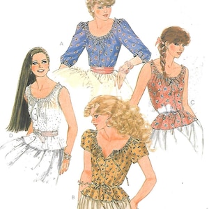 May include: Illustration of four different tops. The tops are in various styles, including a blue floral top with long sleeves, a white eyelet top, a red floral tank top, and a yellow floral top with short sleeves. The tops have different necklines and details.