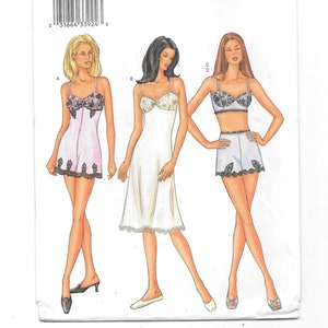 May include: Butterick pattern 3264 featuring illustrations of lingerie designs. The designs include a slip, a camisole and shorts set, and a bra and shorts set. The lingerie is trimmed with lace and has delicate straps. The pattern includes sizes 18, 20, and 22.