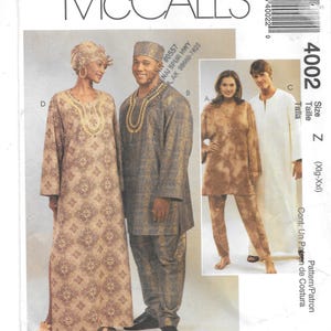 May include: McCall's sewing pattern featuring traditional African-inspired clothing designs. The pattern includes options for a long dress, tunic and pants set, and a long white robe. The size is Xlg-XXl.