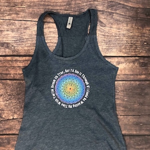 May include: A dark blue tank top with a colorful mandala design and the text "If I Could Be Wasting My Time With A Dream It's True, But I'd See It Through".