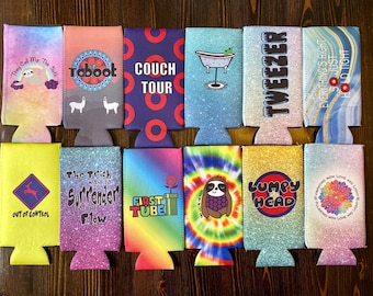 May include: Twelve colorful can coolers with various designs and text. The designs include a sloth, a couch, a bathtub, a flower, a tie-dye pattern, and a rainbow. The text includes "They Call Me The Sloth", "Toboot", "Couch Tour", "Out of Control", "The Trick Was To Surrender To The Flow", "First Tube", "Tweezer", "Everything's Right So Just Hold Tight", "Lumpy Head", and "Vibrating With Love and Light".