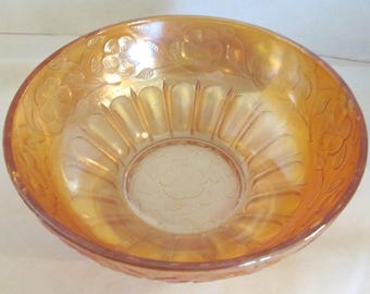 Imperial marigold carnival glass round berry bowl with embossed flowers on top edge and bottom of  bowl, Vintage