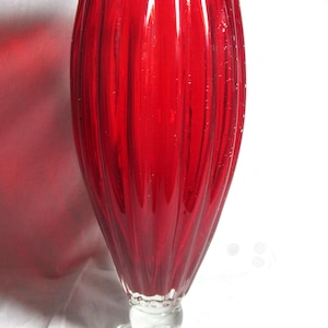 Pairpoint red stretch glass 14 inch ribbed vase with flat rim, with  controlled bubble and clear footed base, Early 1900s