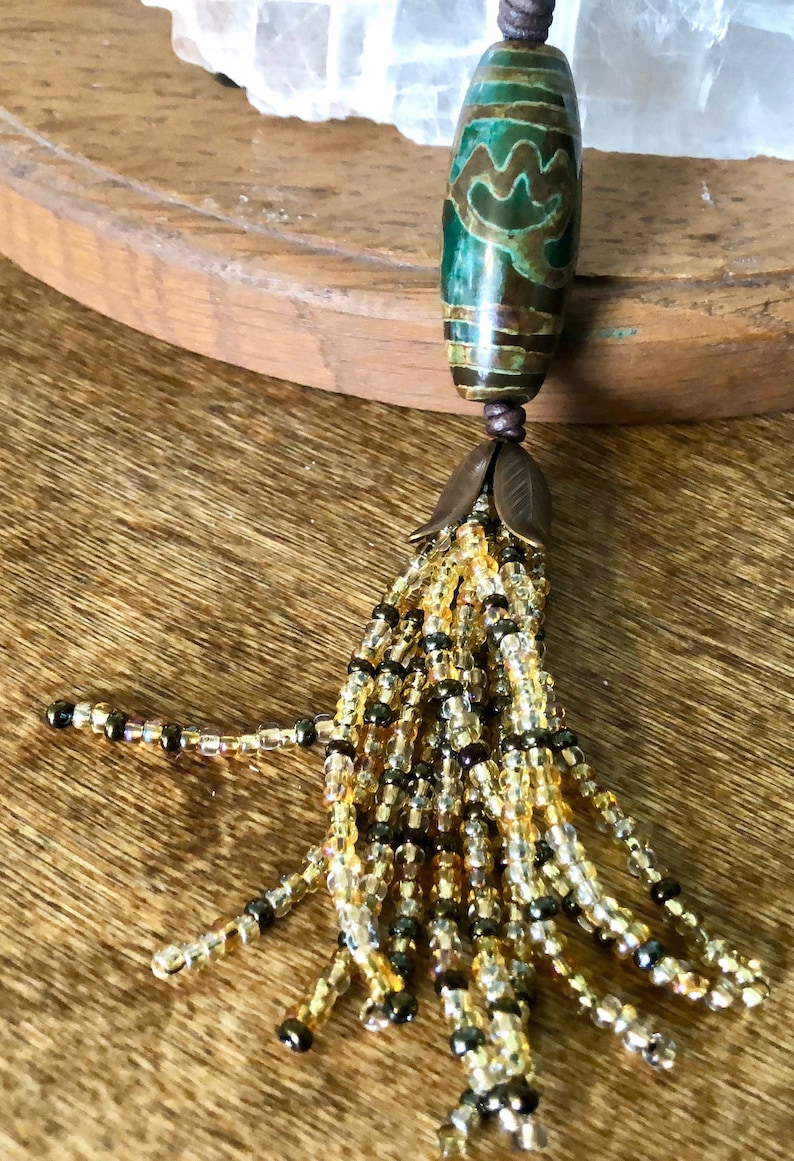 Boho Style Long Adjustable Necklace with a Focal Dzi Style Green /& Bronze Bead with a Gold Tone Beaded Tassle on Dark Brown Natural Leather