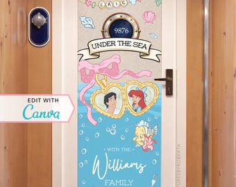 May include: A door decoration featuring a nautical theme with the text "UNDER THE SEA". It includes illustrations of Ariel and Eric, a crab, a starfish, and the family name "Williams". The design incorporates a light blue background with bubbles and decorative elements.
