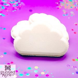 Two white rainbow cloud bath bombs handmade by Rusted Acre Soap Co.