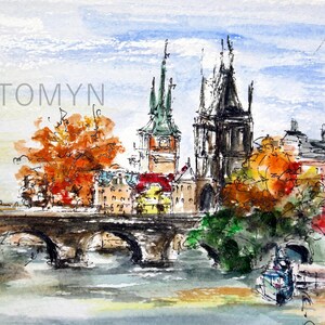 May include: Watercolor painting of a bridge over a river with buildings and trees in the background. The buildings have pointed roofs and the trees are in shades of orange and green. The painting is signed "TOMYN" in the upper left corner.