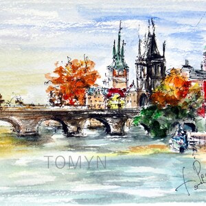 May include: Watercolor painting of a bridge over a river with buildings and trees in the background. The buildings have tall spires and the trees are in shades of green and orange. The painting is signed "Tomyn" in the lower left corner and "Prague" in the lower right corner.