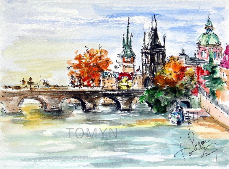 May include: Watercolor painting of a bridge over a river with buildings and trees in the background. The buildings have tall spires and the trees are in shades of green and orange. The painting is signed "Tomyn" in the lower left corner and "Prague" in the lower right corner.