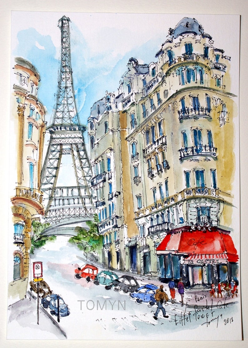 May include: A watercolor painting of a street scene in Paris, France. The Eiffel Tower is visible in the background, and there are buildings and cars in the foreground. A cafe with a red awning is on the right side of the image. The painting is signed "Tomyn" and dated "January 2013".