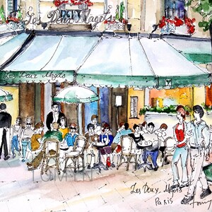 May include: A watercolor painting of a Parisian cafe called "Les Deux Magots" with people sitting at tables outside. The cafe has a green awning and is surrounded by trees. The painting is signed "Tom 7/2016".
