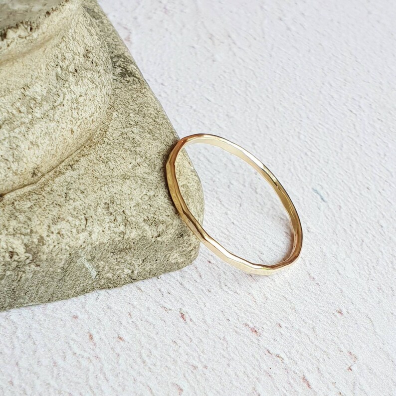 K&ouml;nnte beinhalten: Ein einfacher Goldring mit geh&auml;mmerter Textur.
