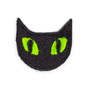 May include: Black felt cat face patch with green embroidered eyes.