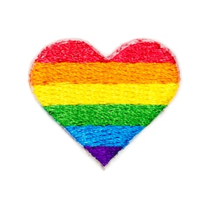 May include: A rainbow heart-shaped patch with red, orange, yellow, green, blue, indigo, and violet stripes.