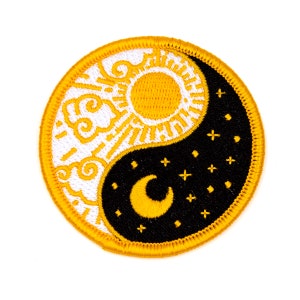 May include: A yellow and black yin yang symbol with a sun and clouds on one side and a crescent moon and stars on the other side.