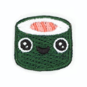 May include: Green embroidered patch of a smiling sushi roll with a pink and white filling.